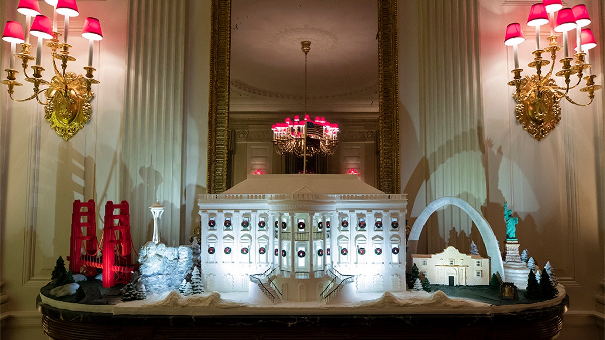 A White House made of gingerbread surrounded by landmarks from around the country in the State Dining Room during the 2019 Christmas preview. (AP Photo/Alex Brandon)