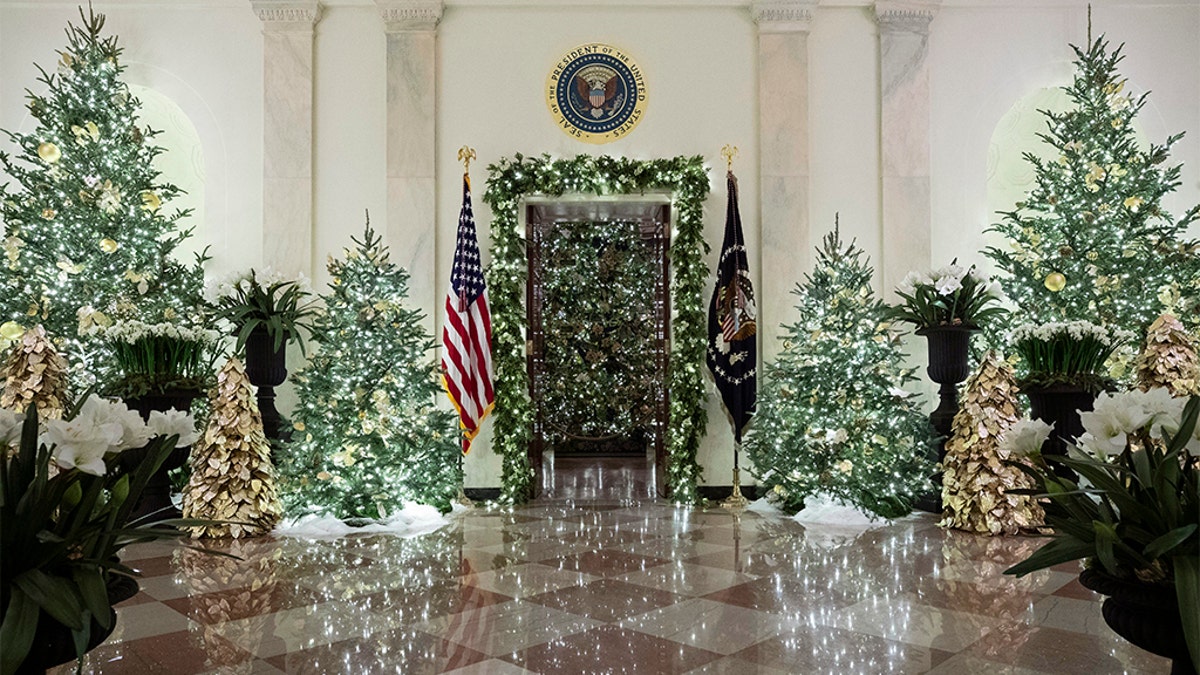 The official White House Christmas tree is decorated in the Blue Room seen through the Cross Hall, during the 2019 Christmas preview at the White House, Monday, Dec. 2, 2019, in Washington. (AP Photo/Alex Brandon)