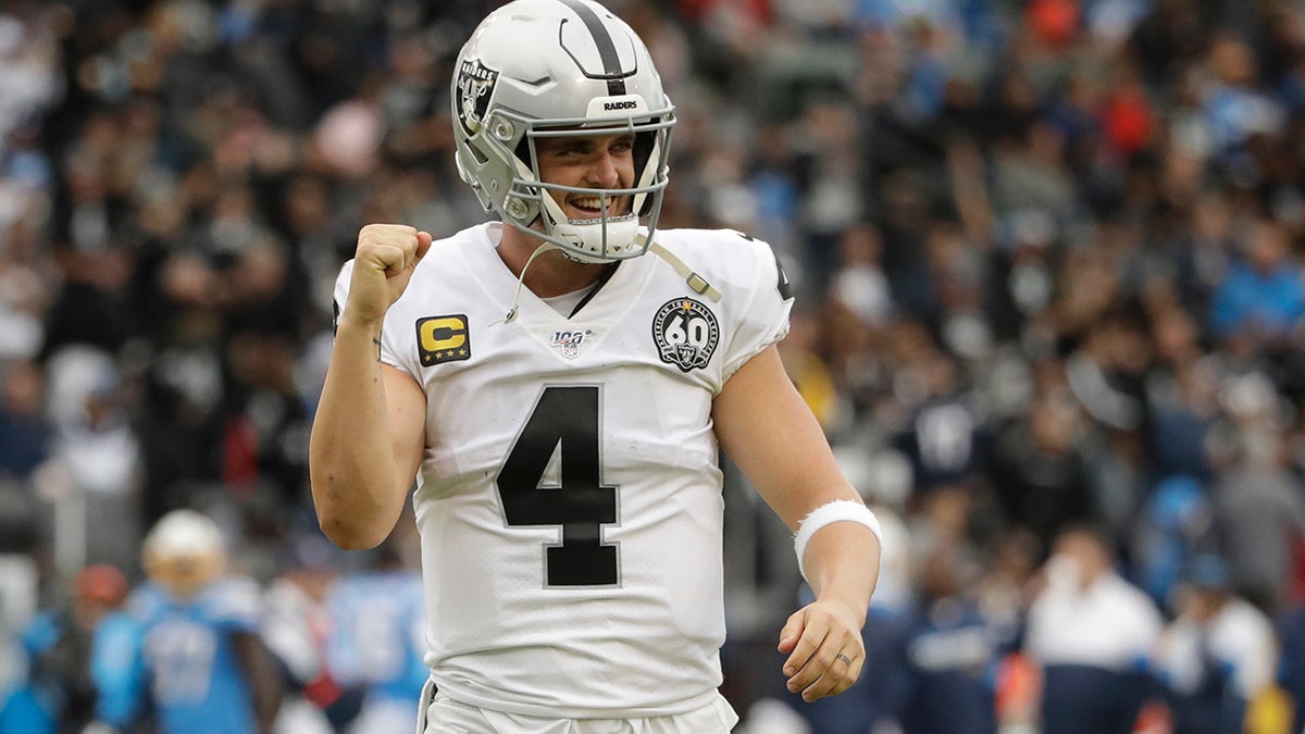 Oakland Raiders quarterback Derek Carr celebrates after a touchdown by running back DeAndre Washington during the second half of an NFL football game against the Los Angeles Chargers Sunday, Dec. 22, 2019, in Carson, Calif. (AP Photo/Marcio Jose Sanchez)