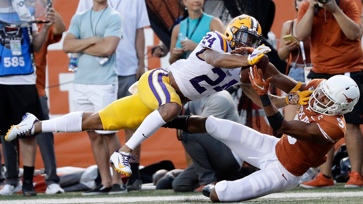 FILE - In this Sept. 7, 2019, file photo, LSU cornerback Derek Stingley Jr., left, breaks up a pass intended for Texas wide receiver Collin Johnson during the first half of an NCAA college football game, in Austin, Texas. Stingley was selected as newcomer of the year on The Associated Press All-Southeastern Conference football team, Monday, Dec. 9, 2019. (AP Photo/Eric Gay, File)