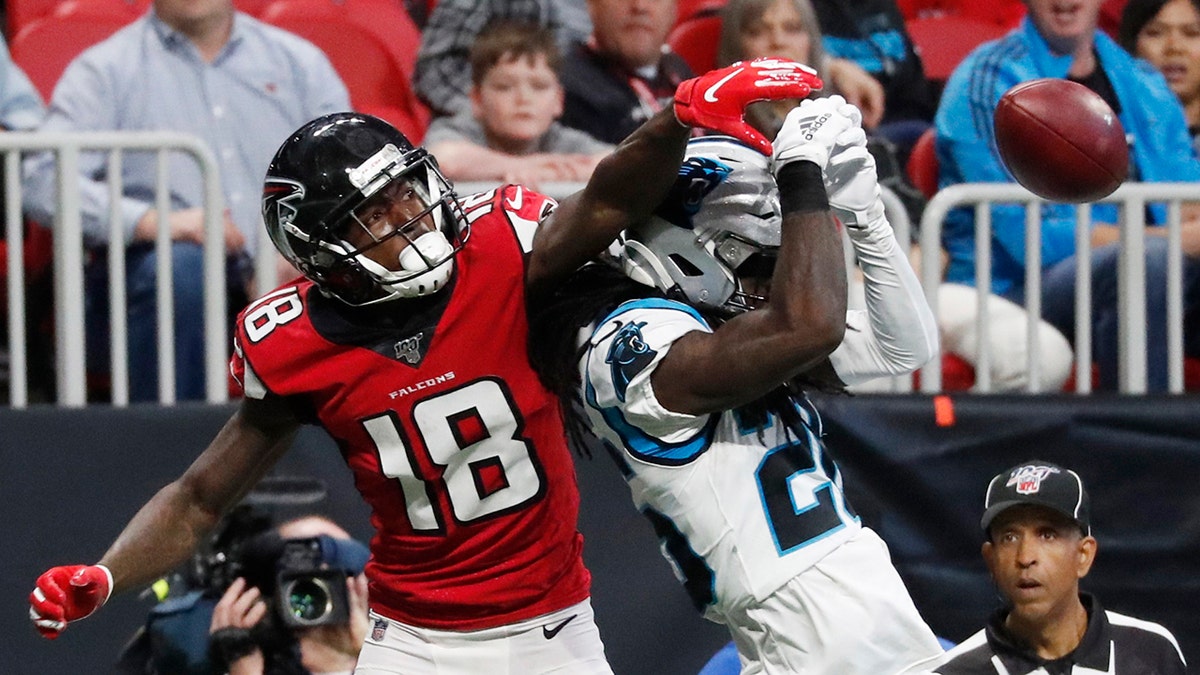 Atlanta Falcons wide receiver Calvin Ridley (18) misses a catch against Carolina Panthers cornerback Donte Jackson (26) during the first half of a December 2019 game in Atlanta.