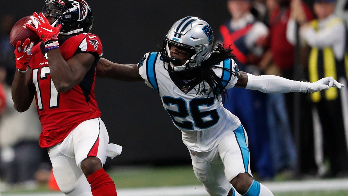 Atlanta Falcons wide receiver Olamide Zaccheaus (17) makes a catch against Carolina Panthers cornerback Donte Jackson (26) during the second half of an NFL football game, Sunday, Dec. 8, 2019, in Atlanta. ran for a touchdown on the play. Zaccheaus(AP Photo/John Bazemore)