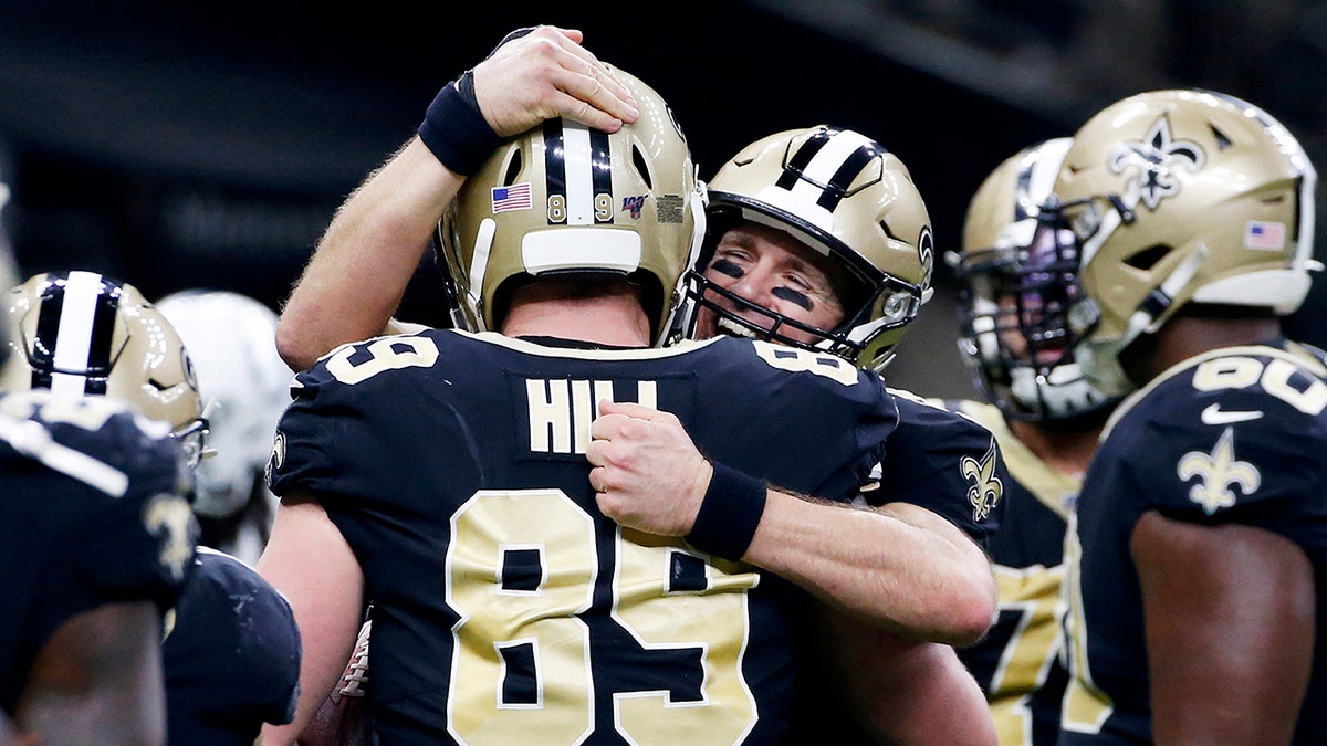 New Orleans Saints quarterback Drew Brees (9) celebrates his touchdown pass to tight end Josh Hill (89), which broke the NFL record for career touchdown passes, surpassing Peyton Manning, in the second half of an NFL football game against the Indianapolis Colts in New Orleans, Monday, Dec. 16, 2019. (AP Photo/Butch Dill)