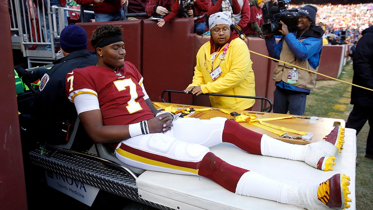 Washington Redskins quarterback Dwayne Haskins sits on cart while being taking off the field during the second half of an NFL football game against the New York Giants, Sunday, Dec. 22, 2019, in Landover, Md. (AP Photo/Patrick Semansky)