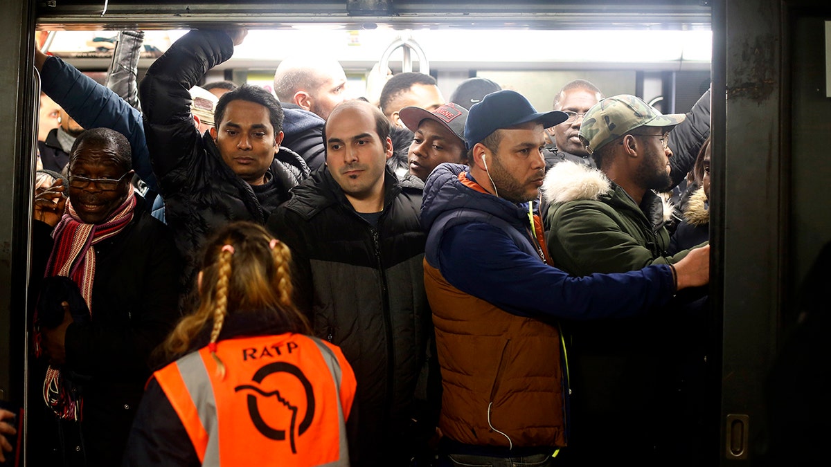 Commuters board in a subway, in Paris, Monday, Dec. 16, 2019. French President Emmanuel Macron suggested Thursday that he was ready to make changes to his plans to overhaul the pension system as a major union warned that nationwide strikes and protests could continue unabated until Christmas. (AP Photo/Thibault Camus)