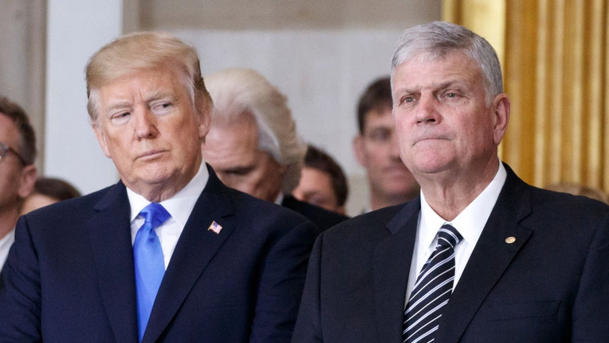 President Donald Trump and first lady Melania Trump stand with Franklin Graham during a ceremony as the late evangelist Billy Graham lies in repose at the U.S. Capitol, on February 28, 2018 in Washington, DC.  (Photo by Shawn Thew-Pool/Getty Images)