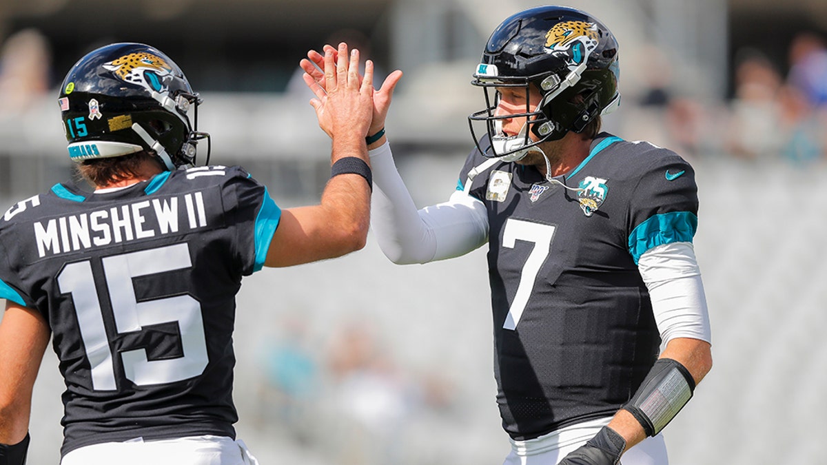 Gardner Minshew #15 of the Jacksonville Jaguars and Nick Foles #7 warm up before the start of a game against the Tampa Bay Buccaneers. (Photo by James Gilbert/Getty Images)