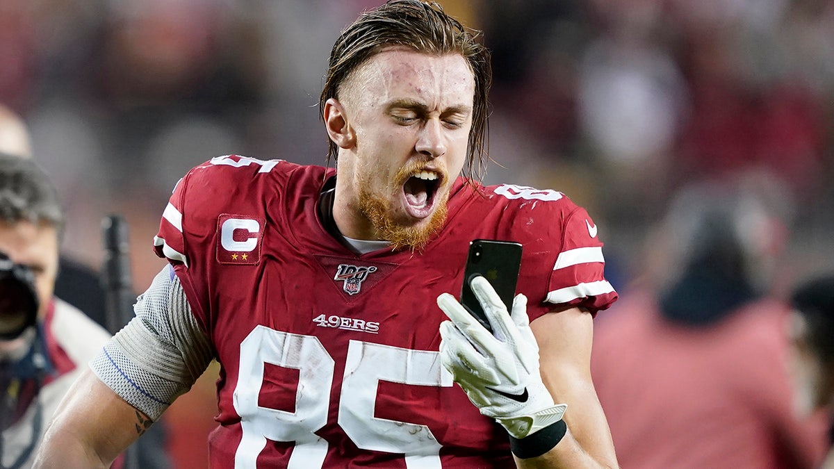 San Francisco 49ers tight end George Kittle yells into a phone while celebrating after the 49ers defeated the Los Angeles Rams in an NFL football game in Santa Clara, Calif., Saturday, Dec. 21, 2019. (AP Photo/Tony Avelar)