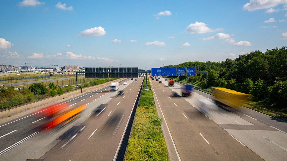 Multilane Autobahn highway with blurred trucks and cars near Frankfurt Airport, Frankfurter Kreuz, Germany