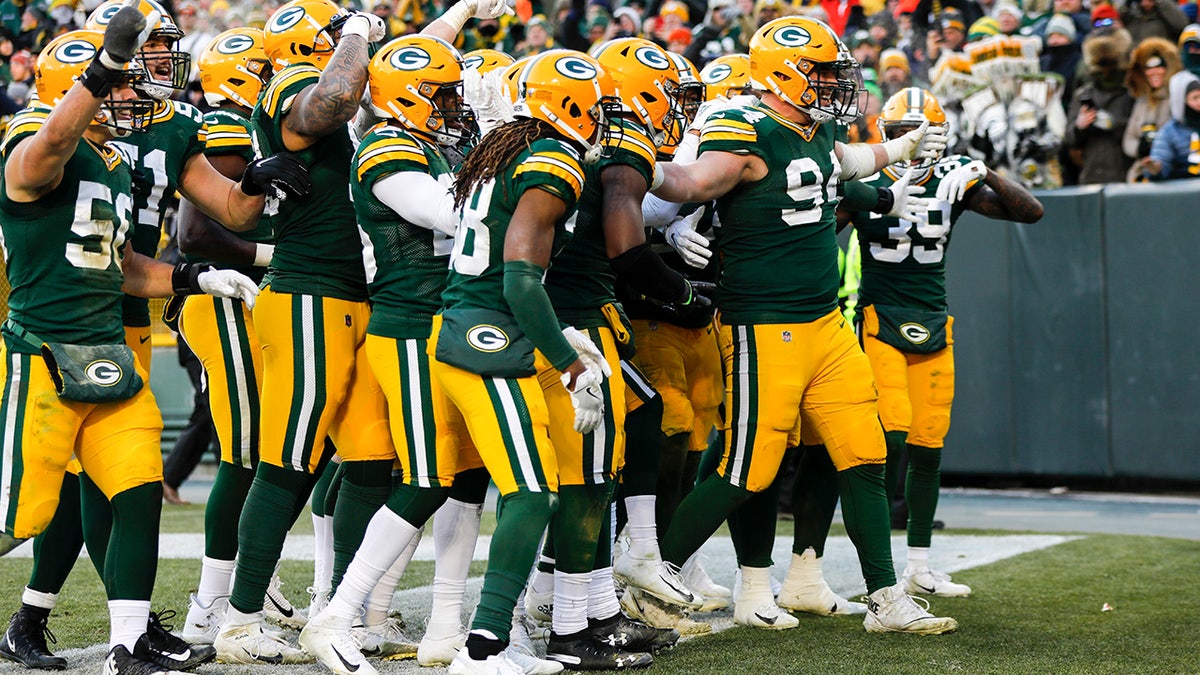Green Bay Packers' Dean Lowry celebrates his interception with teammates during the second half of an NFL football game against the Chicago Bears Sunday, Dec. 15, 2019, in Green Bay, Wis. (AP Photo/Mike Roemer)