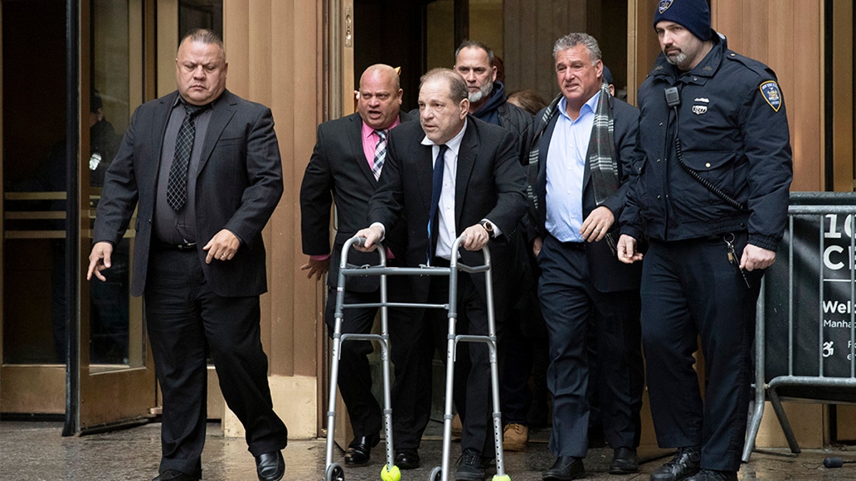 Harvey Weinstein, center, leaves court following a hearing in New York on Dec. 11.