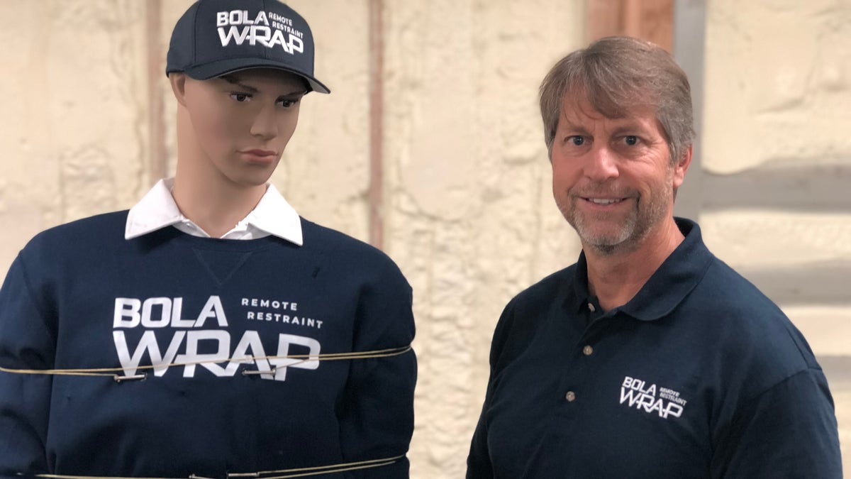 David Norris, Wrap Technologies CEO, demonstrates the BolaWrap on a mannequin.
