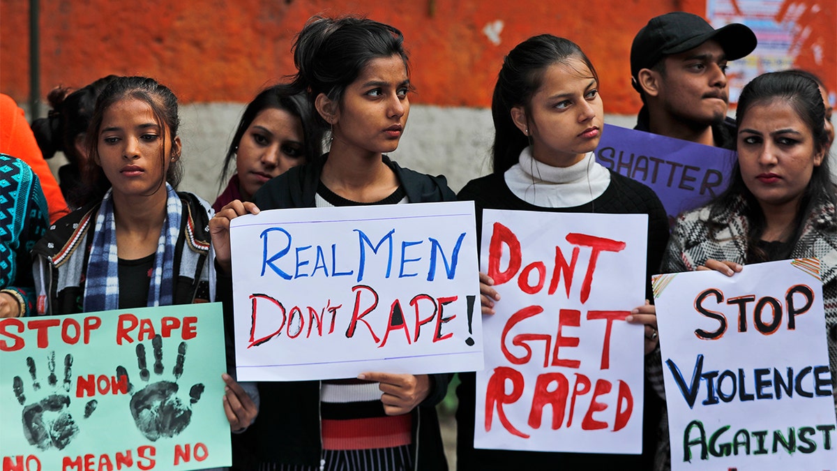 Women activists hold banners and participate in a protest demanding justice in the case of a veterinarian who was gang-raped and killed last week, in New Delhi, India, Tuesday, Dec. 3, 2019.  (AP Photo/Manish Swarup)