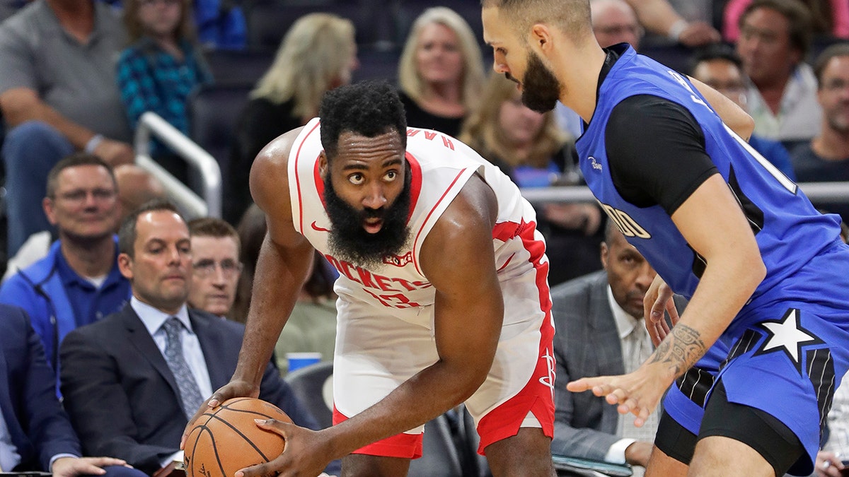 Houston Rockets' James Harden, left, looks for a way past Orlando Magic's Evan Fournier during the first half of an NBA basketball game, Friday, Dec. 13, 2019, in Orlando, Fla. (AP Photo/John Raoux)