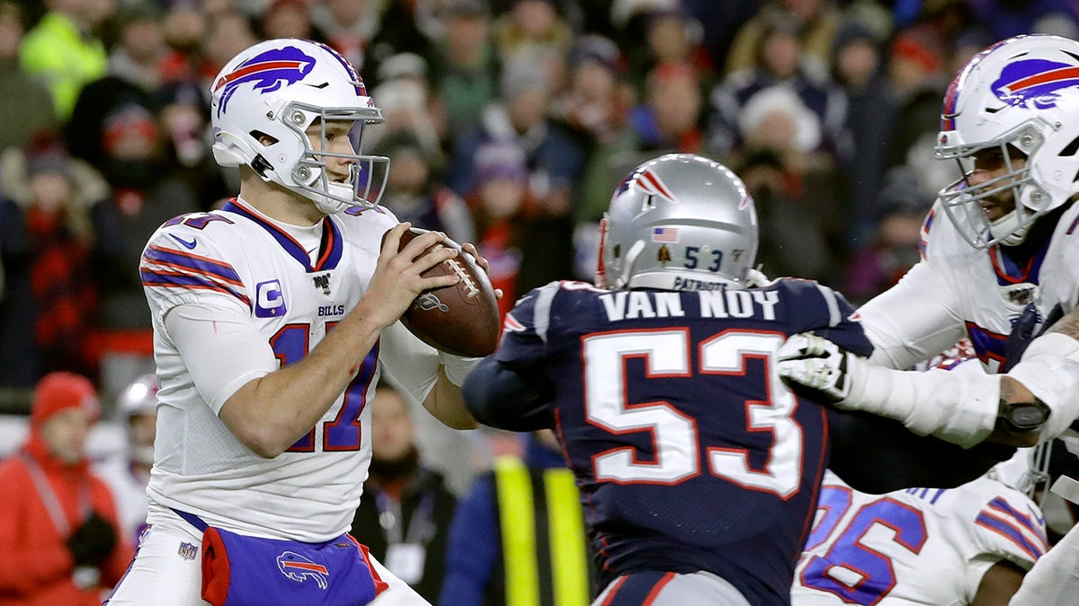 Buffalo Bills quarterback Josh Allen, left, drops back to pass under pressure from New England Patriots linebacker Kyle Van Noy in the second half of an NFL football game, Saturday, Dec. 21, 2019, in Foxborough, Mass. (AP Photo/Elise Amendola)