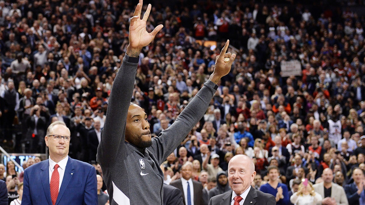 Former Toronto Raptors and now Los Angeles Clippers forward Kawhi Leonard salutes the crowd as he receives his 2019 NBA championship ring prior to an NBA basketball game, Wednesday, Dec. 11, 2019, in Toronto. (Nathan Denette/The Canadian Press via AP)