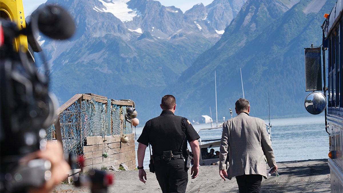 Frank Parlato and Lt. Nickell walking down towards the harbor. Production crew included.