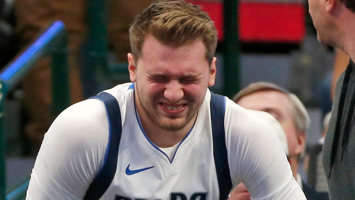 Dallas Mavericks forward Luka Doncic (77) reacts after injuring himself against the Miami Heat during the first half of an NBA basketball game in Dallas, Saturday, Dec 14, 2019. (AP Photo/Michael Ainsworth)