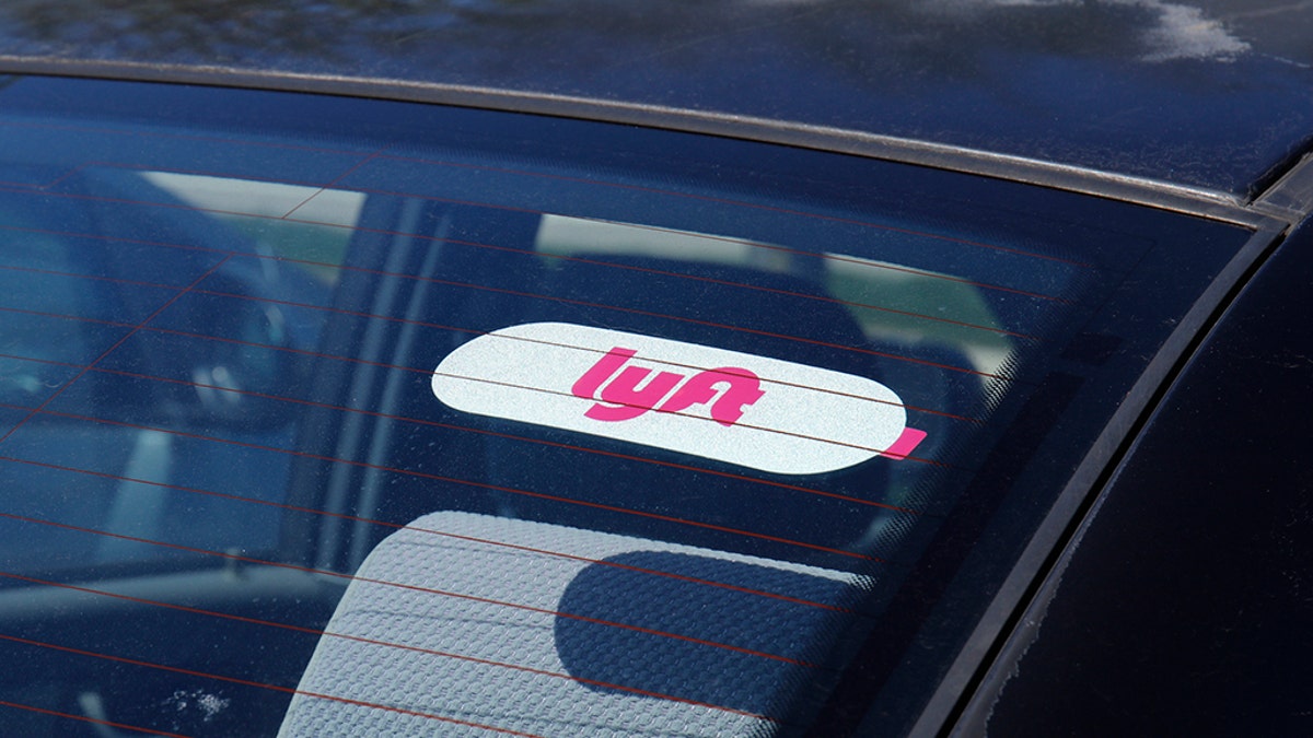 A Lyft sticker in the window of a car