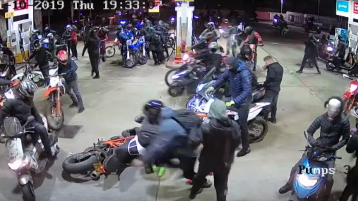 The large group of men on motorbikes swarmed a gas station on Halloween night.