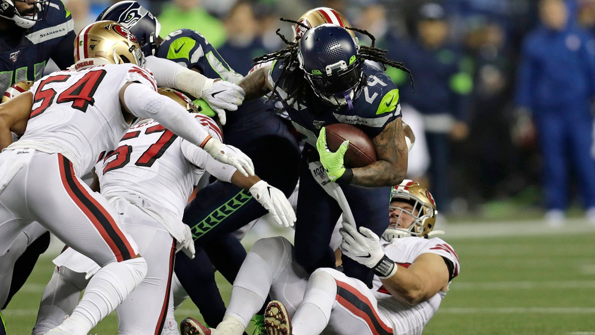 Seattle Seahawks' Marshawn Lynch (24) carries on a fourth-and-one but is pulled down short during the first half of an NFL football game against the San Francisco 49ers, Sunday, Dec. 29, 2019, in Seattle. (AP Photo/Stephen Brashear)