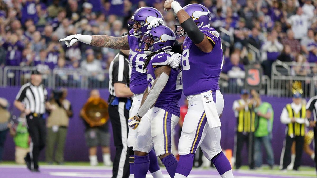 Minnesota Vikings running back Mike Boone, center, celebrates with teammates after scoring on a 1-yard touchdown run during the second half of an NFL football game against the Chicago Bears, Sunday, Dec. 29, 2019, in Minneapolis. (AP Photo/Andy Clayton-King)