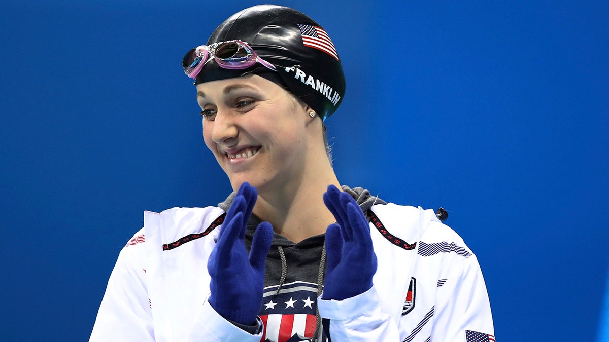 In this Aug. 11, 2016 file photo United States' Missy Franklin wears gloves as she prepares for a women's 200-meter backstroke semifinal during the swimming competitions at the 2016 Summer Olympics in Rio de Janeiro, Brazil. (AP Photo/Lee Jin-man, file)