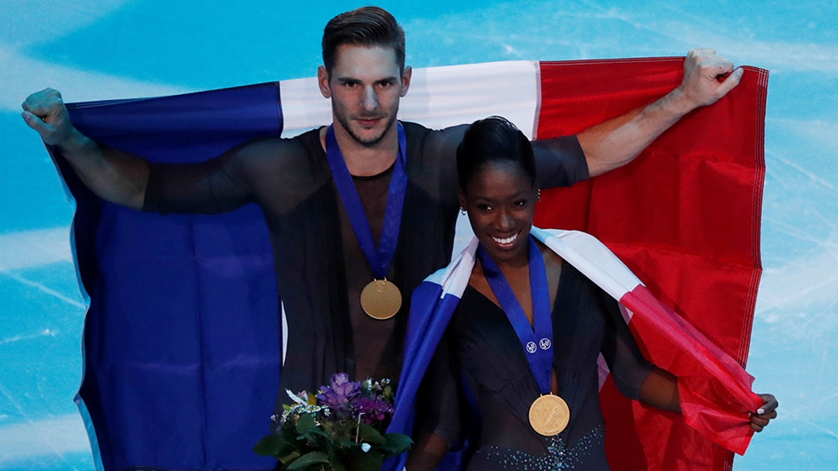 France's Vanessa James and Morgan Cipres celebrate first place in the Pairs Free Skating.