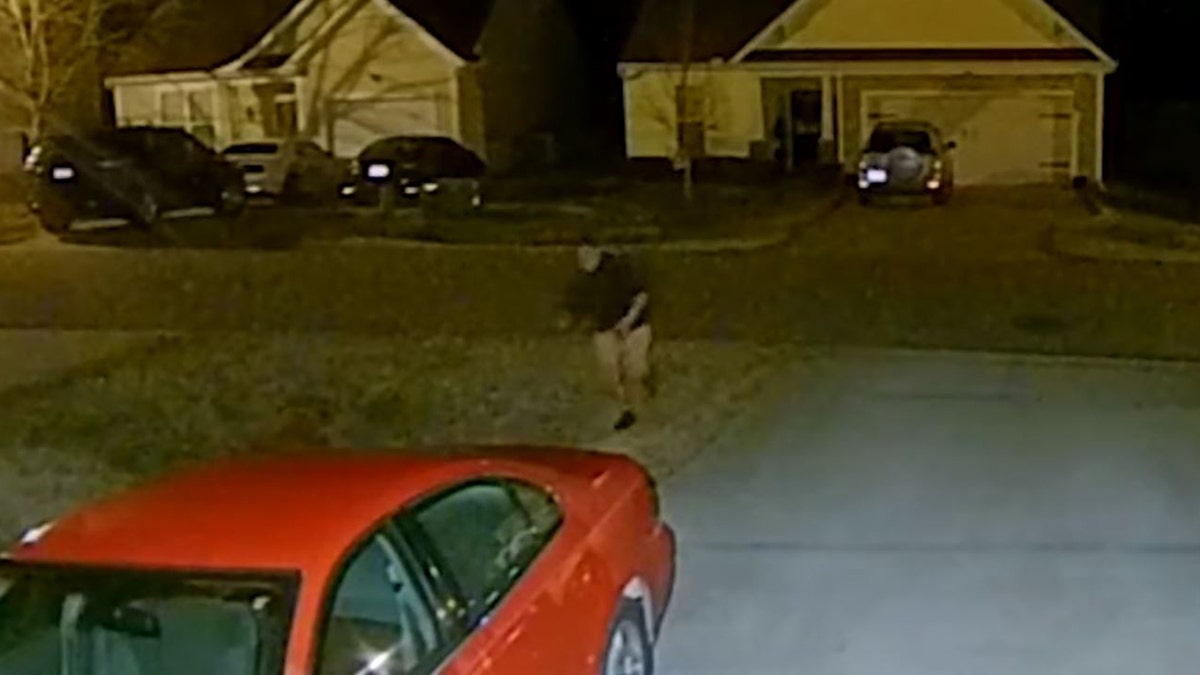 The ma appeared to be half-clothed while running across a street and into a backyard, where he crouched next to a grill.