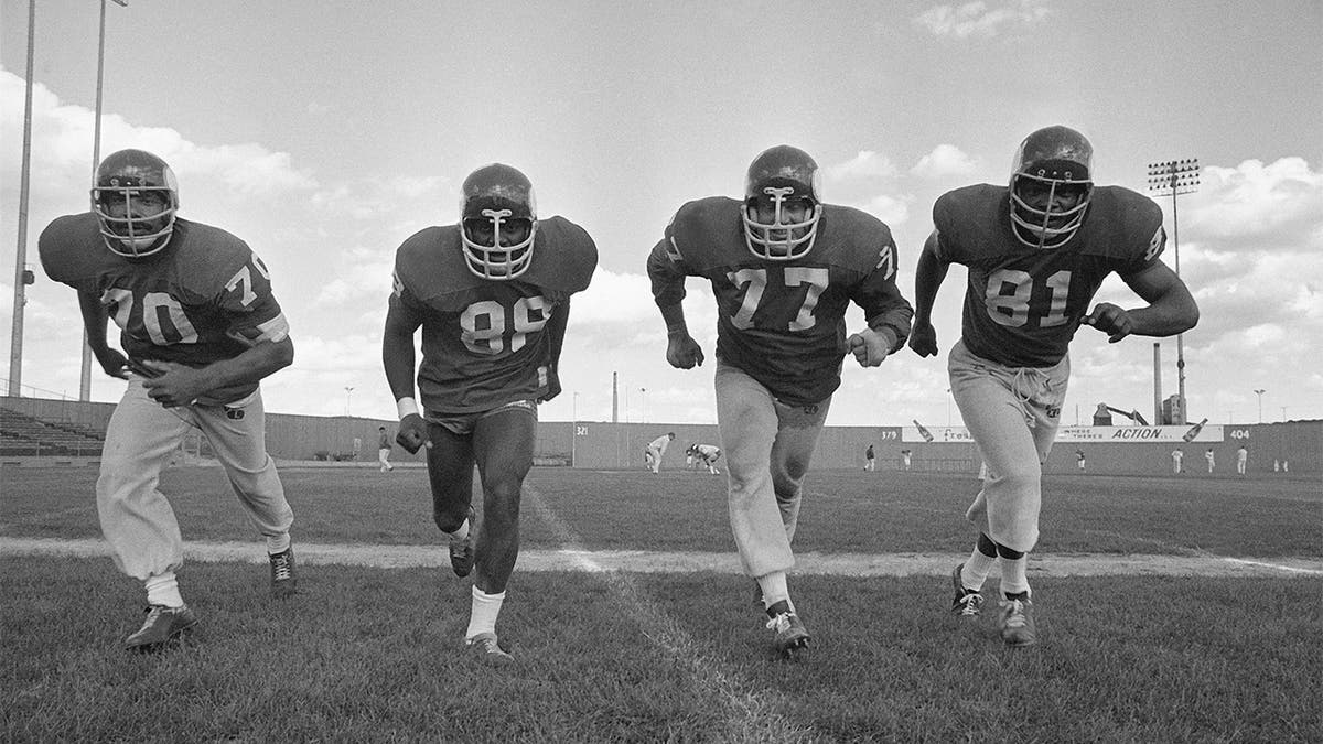 In this Sept. 16, 1971 photo, the powerful defensive front four of the Minnesota Vikings , from left, Jim Marshall, Alan Page, Gary Larson, Carl Eller pose during NFL football practiced in Minneapolis. Helmets have evolved from the original hard leather of the NFL’s infancy to hard polycarbonate single-piece shells with various amounts of padding and air bladders that served as the primary form of head protection into the beginning of this century. (AP Photo/File)