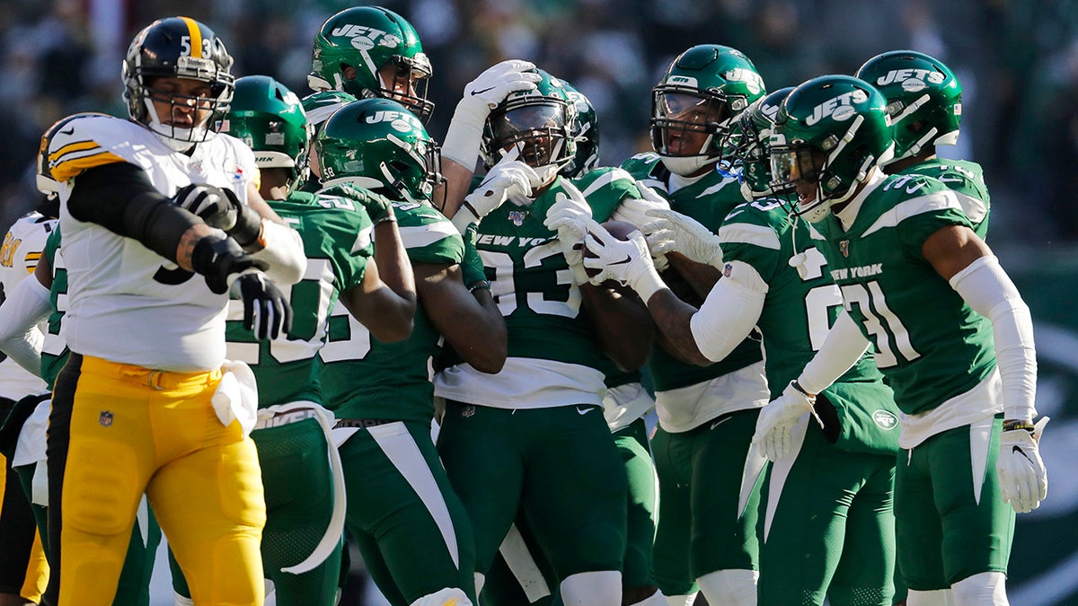 New York Jets linebacker Tarell Basham (93) celebrates an interception with teammates in the first half of an NFL football game against the Pittsburgh Steelers, Sunday, Dec. 22, 2019, in East Rutherford, N.J. (AP Photo/Adam Hunger)