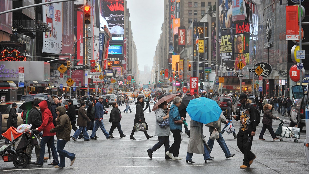Crowds of New Yorkers and visitors cross the street in Times Square. (FILE)
