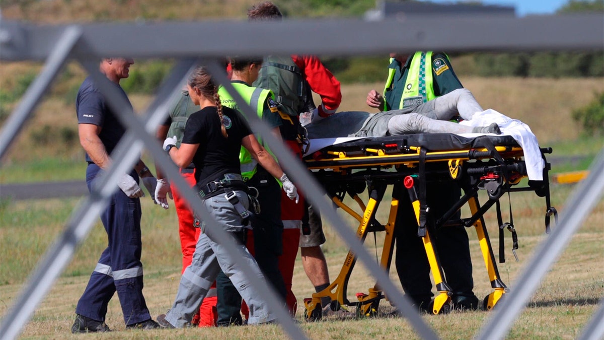 Emergency services attend to an injured person arriving at the Whakatane Airfield after the volcanic eruption Monday, Dec. 9, 2019, on White Island, New Zealand. (Alan Gibson/New Zealand Herald via AP)