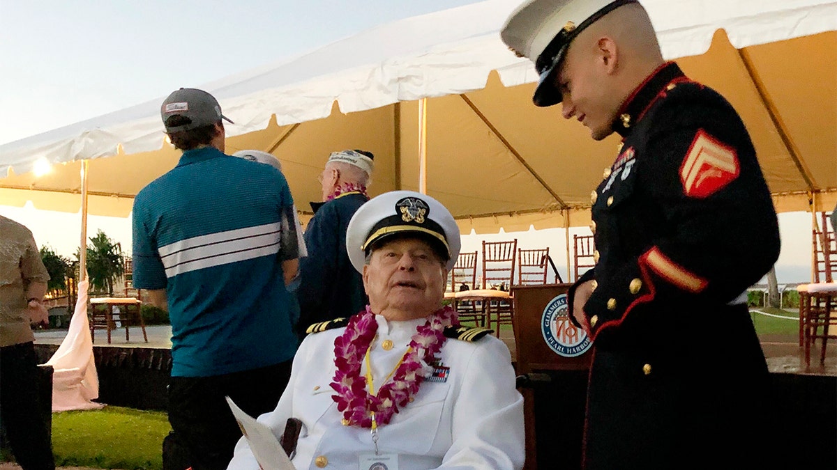 Marine Cpl. Zachariah Jeavons, 22, of Binghamton, N.Y., meets Pearl Harbor survivor Lou Conter, 98, who was aboard the USS Arizona when the Japanese attacked in 1941, Saturday, Dec. 7, 2019 at Pearl Harbor, Hawaii on the 78th anniversary of the attack. (AP Photo/Caleb Jones)