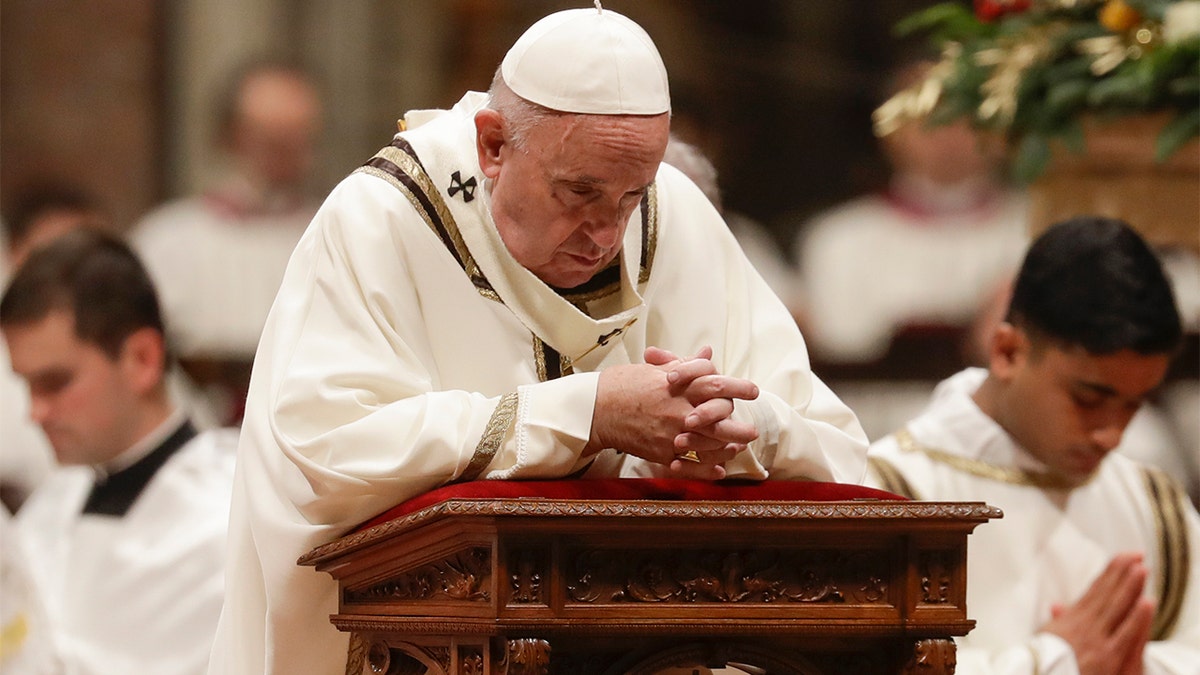 Pope Francis prays during Christmas Eve Mass in St. Peter's Basilica at the Vatican, Tuesday, Dec. 24, 2019. (AP Photo/Alessandra Tarantino)