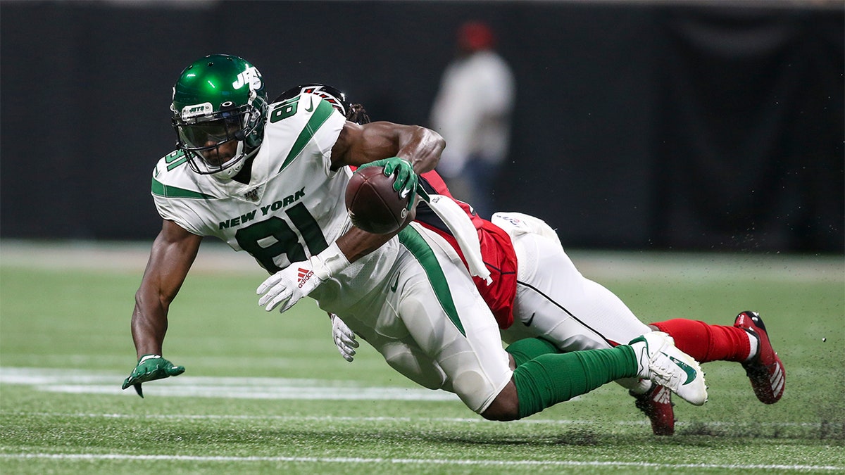 New York Jets wide receiver Quincy Enunwa (81) is tackled by Atlanta Falcons cornerback Desmond Trufant (21) in the second quarter at Mercedes-Benz Stadium.