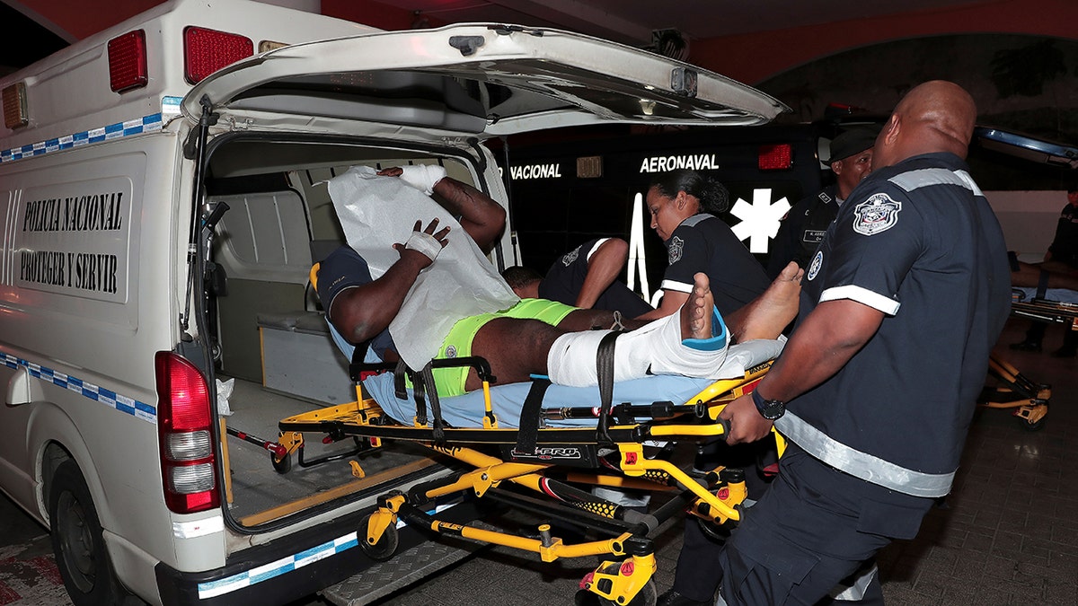 An injured inmate is carried on a stretcher into a hospital by police paramedics after a shootout among inmates at La Joyita jail, east of Panama City, Panama, on Tuesday. (Reuters)