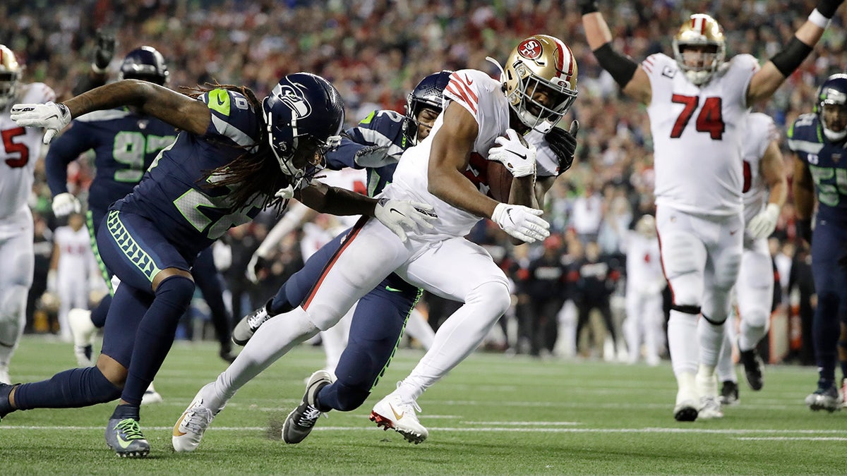 San Francisco 49ers' Raheem Mostert scores against the Seattle Seahawks during the second half of an NFL football game, Sunday, Dec. 29, 2019, in Seattle. (AP Photo/Ted S. Warren)