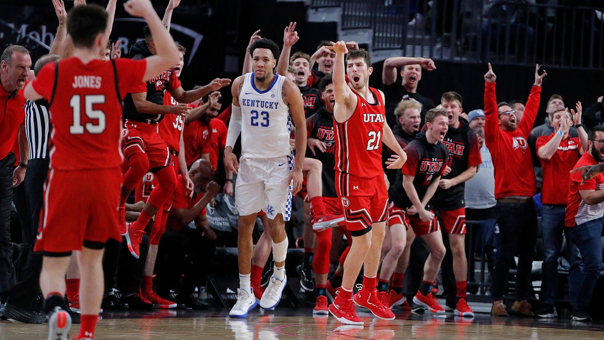 Utah's Riley Battin (21) celebrates after making a 3-point shot against Kentucky during the second half of an NCAA college basketball game Wednesday, Dec. 18, 2019, in Las Vegas. (AP Photo/John Locher)