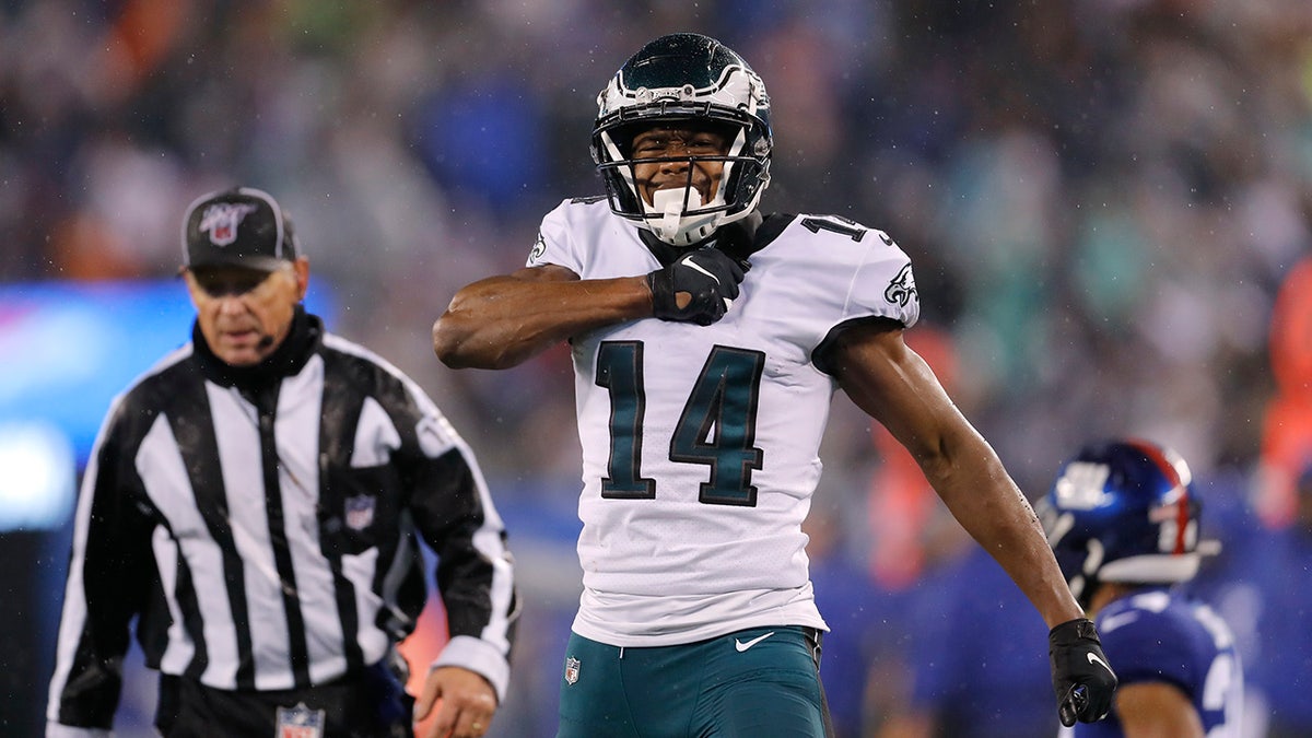 Philadelphia Eagles wide receiver Robert Davis (14) celebrates catching a pass in front of New York Giants cornerback Julian Love in the second half of an NFL football game, Sunday, Dec. 29, 2019, in East Rutherford, N.J. (AP Photo/Adam Hunger)