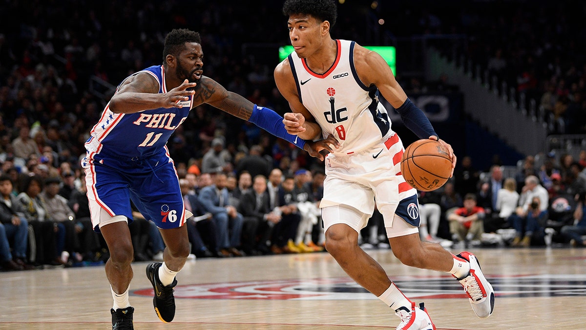 Washington Wizards forward Rui Hachimura (8), of Japan, dribbles the ball as he is defended by Philadelphia 76ers forward James Ennis III (11) during the second half of an NBA basketball game, Thursday, Dec. 5, 2019, in Washington. The Wizards won 119-113. (AP Photo/Nick Wass)