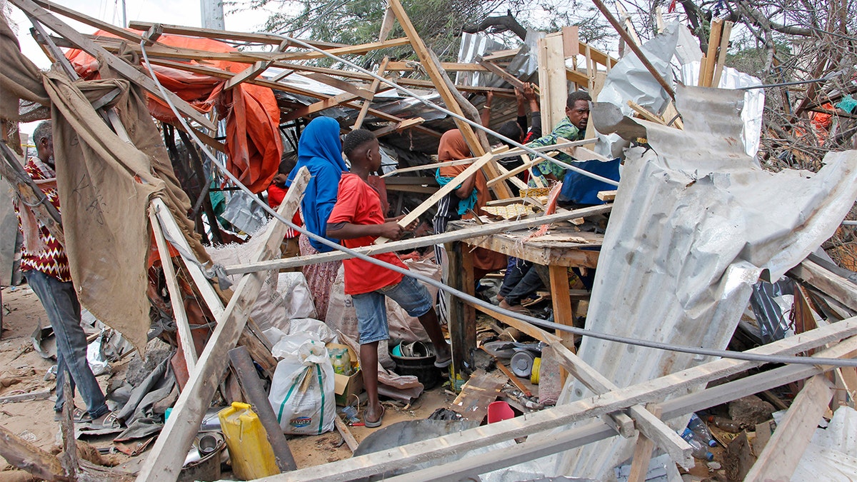 People salvaging goods after a car bomb destroyed shops in Mogadishu, Somalia, on Saturday. (AP Photo/Farah Abdi Warsame)