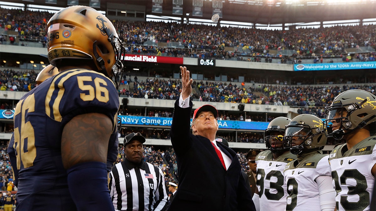 President Donald Trump throws the coin before the start of the Army-Navy college football game in Philadelphia, Saturday, Dec. 14, 2019. (AP Photo/Jacquelyn Martin)