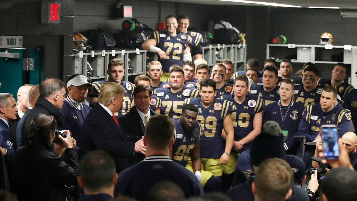 President Donald Trump greets the Navy football team in Philadelphia, Saturday, Dec. 14, 2019, before the Army-Navy college football game. (AP Photo/Jacquelyn Martin)