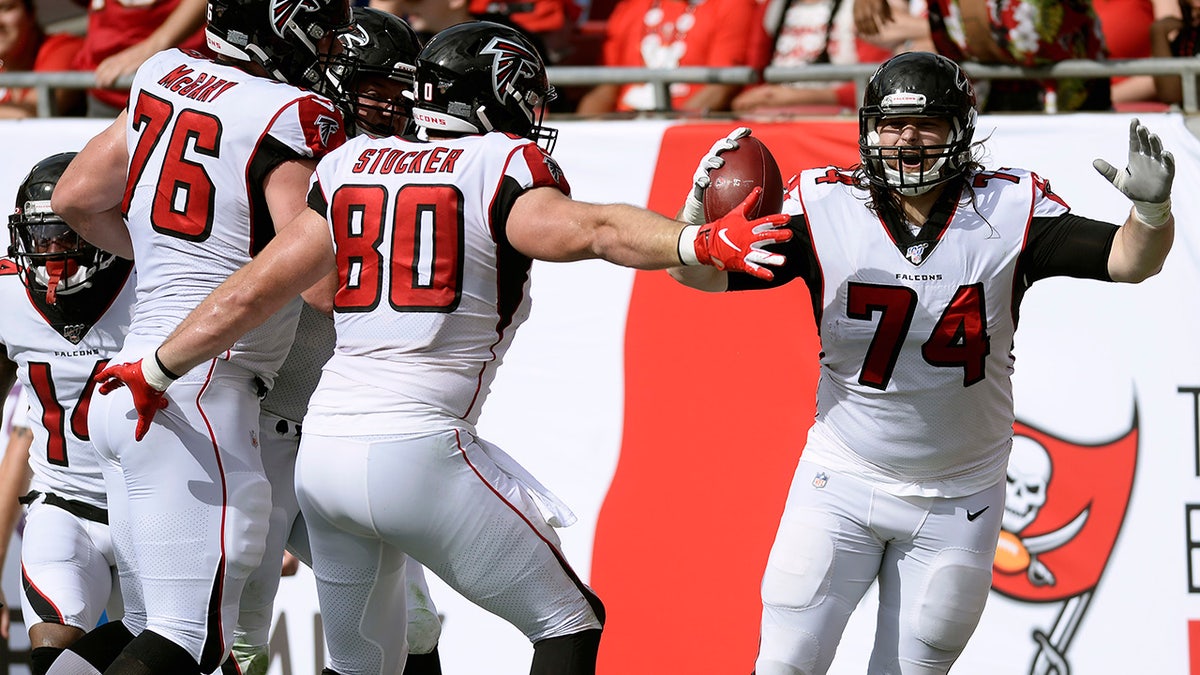 Atlanta Falcons offensive tackle Ty Sambrailo (74) celebrates his 35-yard touchdown reception with tight end Luke Stocker (80) and offensive tackle Kaleb McGary (76) during the first half of an NFL football game against the Tampa Bay Buccaneers Sunday, Dec. 29, 2019, in Tampa, Fla. (AP Photo/Jason Behnken)