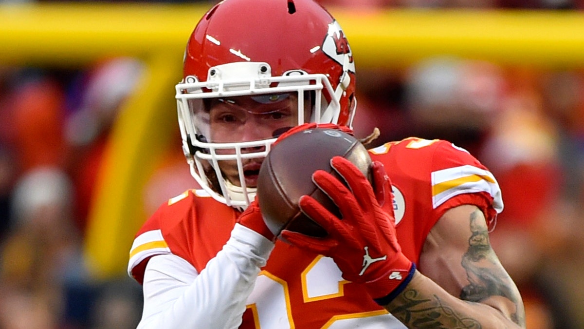 Kansas City Chiefs safety Tyrann Mathieu (32) intercepts a pass intended for Oakland Raiders tight end Darren Waller (83) during the first half of an NFL football game in Kansas City, Mo., Sunday, Dec. 1, 2019. (AP Photo/Ed Zurga)