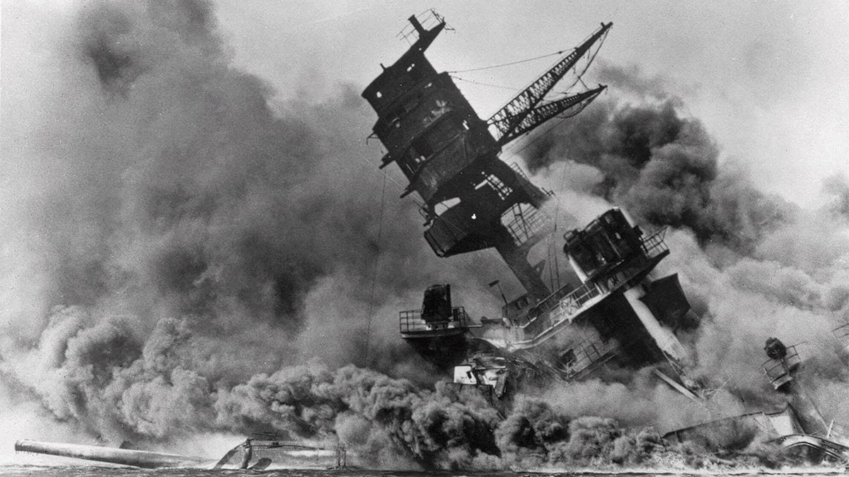 FILE - In this Dec. 7, 1941, file photo, smoke rises from the battleship USS Arizona as it sinks during the Japanese attack on Pearl Harbor, Hawaii. (AP Photo, File)
