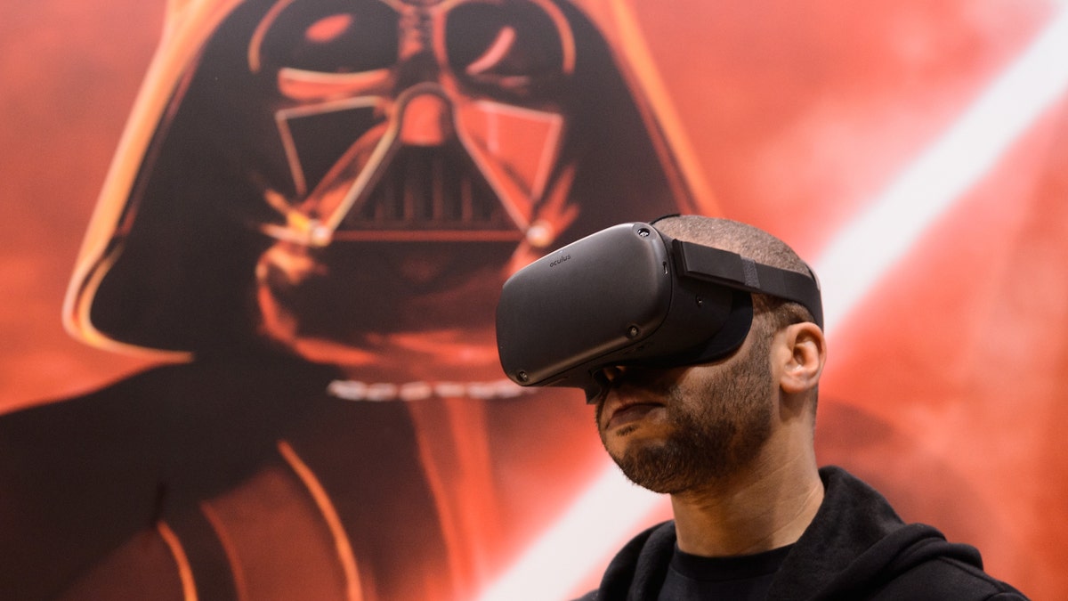 An attendee plays the 'Vader Immortal: A Star Wars VR Series" experience on the Oculus Quest during Star Wars Celebration at McCormick Place Convention Center on April 15, 2019 in Chicago, Illinois - file photo.
