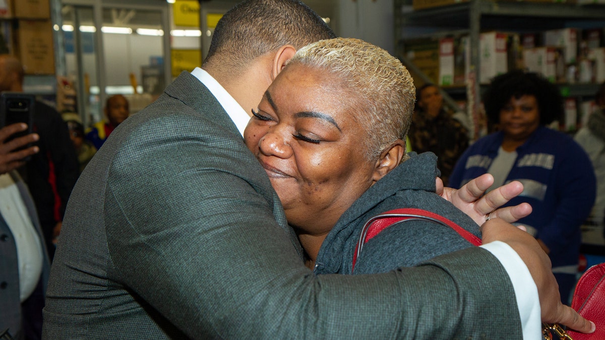 Suwanda McCreary hugs Cascade United Methodist Church senior pastor, Kevin Murriel, after his church paid for $10,000 worth of items in layaway at an Atlanta-area Walmart. McCreary's 28-year-old son died in April and he left three kids behind. She said it meant a lot to her.