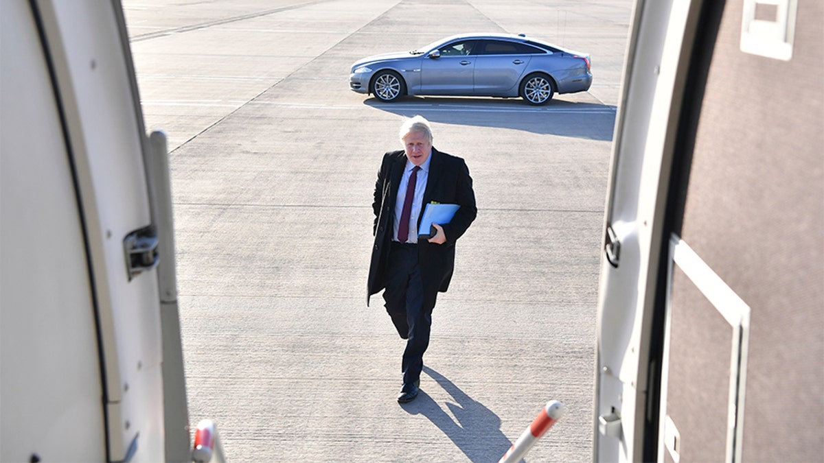 Britain's Prime Minister and Conservative Party leader Boris Johnson boards a plane at Doncaster Sheffield Airport in Doncaster, England, on Monday, during campaigning ahead of the general election on Dec. 12.?